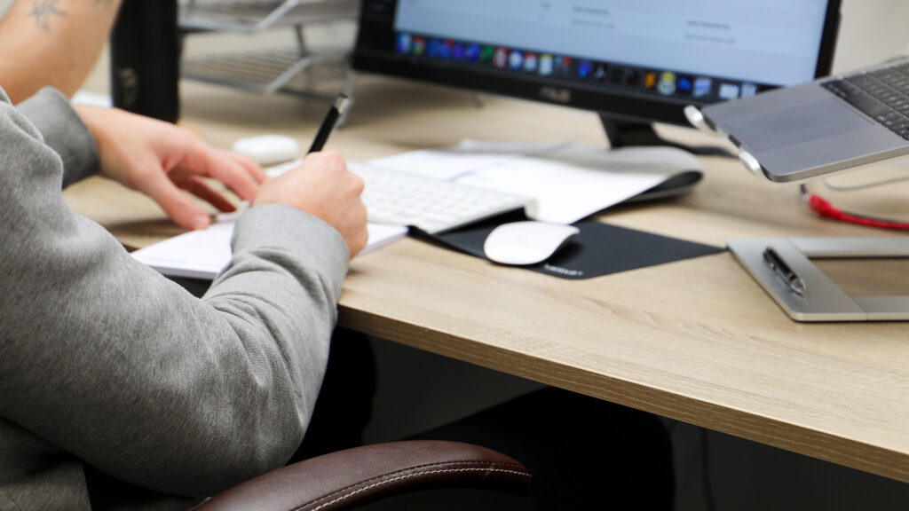 Cornerstone team member makes notes with pen in hand