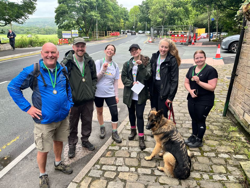 Cornerstone's 'Peaky Climbers' posing with their Saddleworth Three Peaks Challenge medals